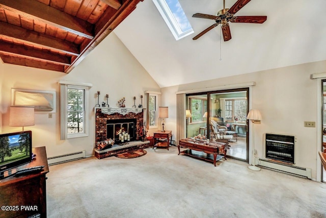 living room with carpet floors, a brick fireplace, a baseboard radiator, and a skylight