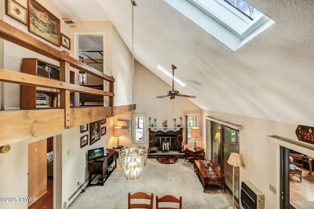 living room with heating unit, light carpet, a baseboard radiator, ceiling fan, and a fireplace