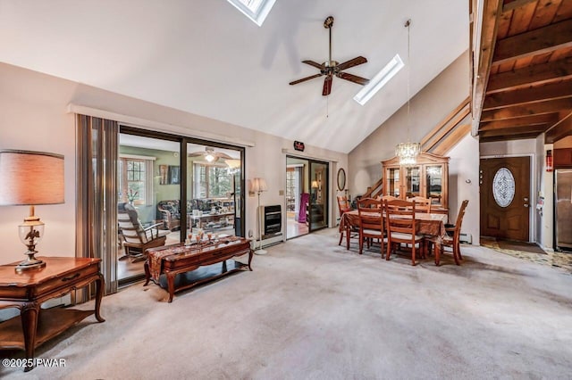 carpeted dining room with a skylight, high vaulted ceiling, and ceiling fan