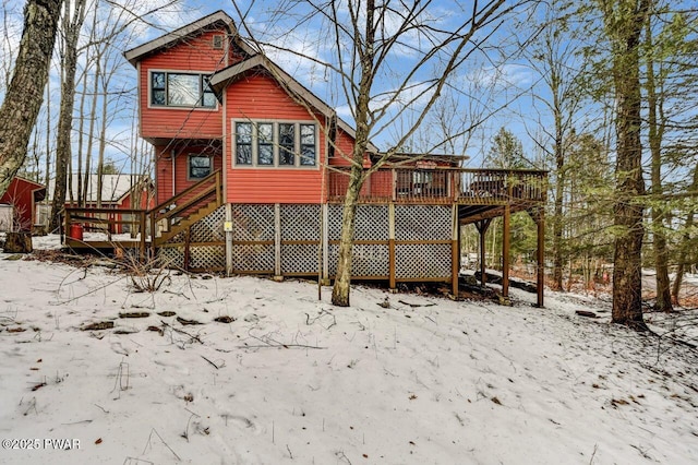 snow covered property featuring a deck