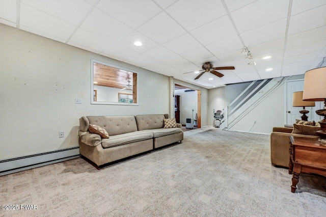 carpeted living room featuring ceiling fan, a paneled ceiling, and baseboard heating