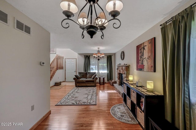 32 Forest Ln, Lake Ariel, PA 18436 - living area featuring a chandelier, stairs, light wood-style flooring, and a fireplace