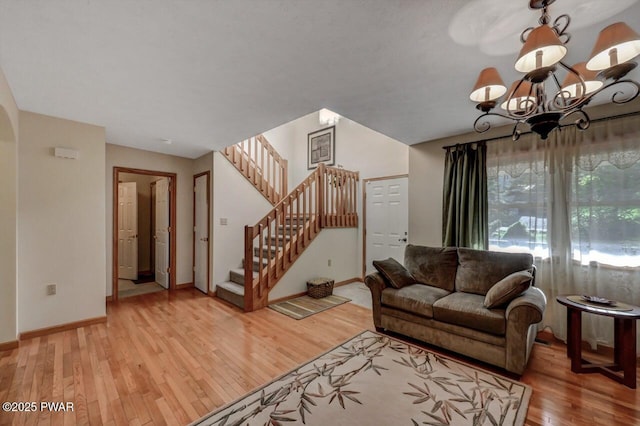 32 Forest Ln, Lake Ariel, PA 18436 - living area featuring light wood-type flooring, baseboards, stairs, a chandelier, and arched walkways