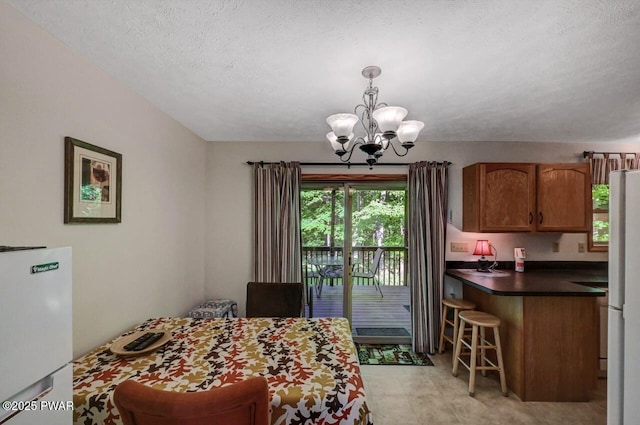 32 Forest Ln, Lake Ariel, PA 18436 - dining space featuring a chandelier and a textured ceiling