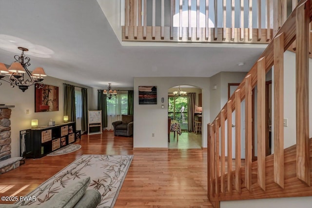 32 Forest Ln, Lake Ariel, PA 18436 - living room featuring a chandelier, light wood-type flooring, arched walkways, and stairs
