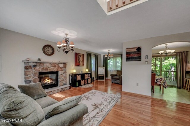 32 Forest Ln, Lake Ariel, PA 18436 - living area with a chandelier, arched walkways, light wood-type flooring, and a fireplace