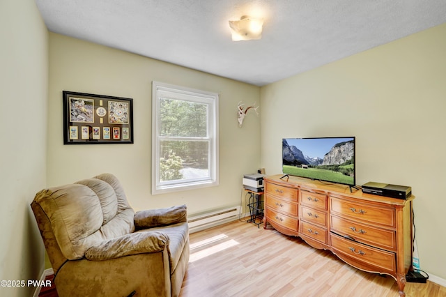 101 Bayberry Dr, Milford, PA 18337 - living area with a baseboard heating unit, light wood-style flooring, and baseboards