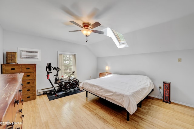 101 Bayberry Dr, Milford, PA 18337 - bedroom featuring a baseboard heating unit, vaulted ceiling, a skylight, light wood-style flooring, and an AC wall unit