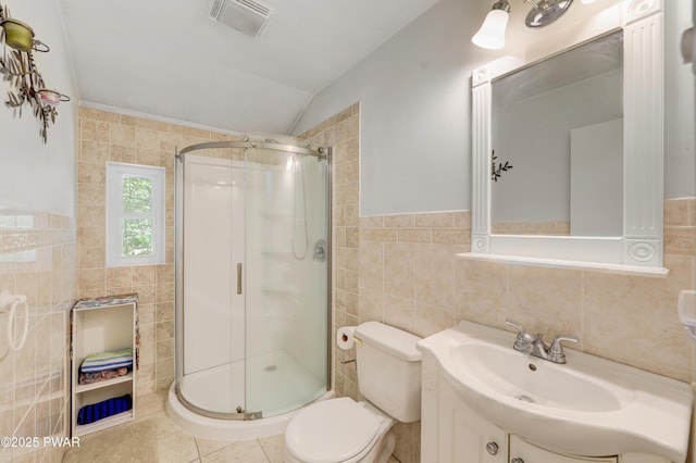 101 Bayberry Dr, Milford, PA 18337 - bathroom featuring tile walls, vaulted ceiling, a shower stall, toilet, and tile patterned flooring