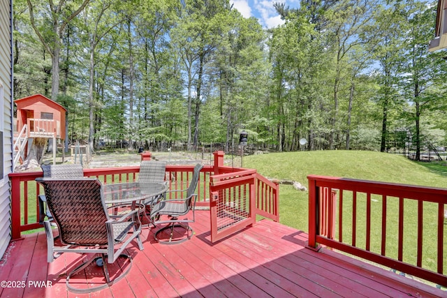 101 Bayberry Dr, Milford, PA 18337 - wooden deck with outdoor dining space, a lawn, and view of scattered trees