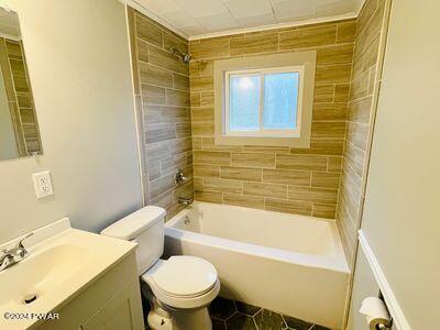 full bathroom with vanity, toilet, and tiled shower / bath