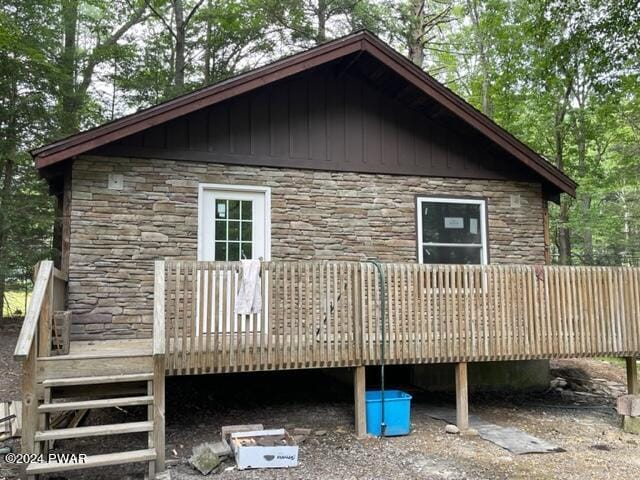 back of house featuring a wooden deck