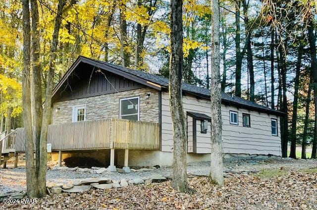 view of side of property featuring a wooden deck