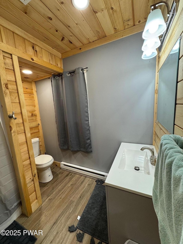8 Kaiser Strasse, Beach Lake, PA 18405 - bathroom featuring baseboard heating, toilet, vanity, wooden ceiling, and wood finished floors