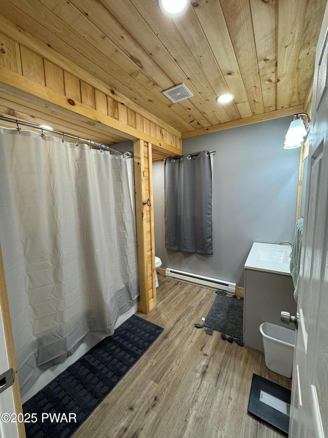 8 Kaiser Strasse, Beach Lake, PA 18405 - full bathroom with baseboard heating, vanity, wood ceiling, toilet, and wood finished floors
