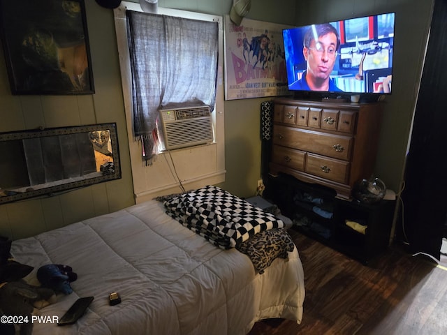 bedroom featuring dark hardwood / wood-style flooring and cooling unit