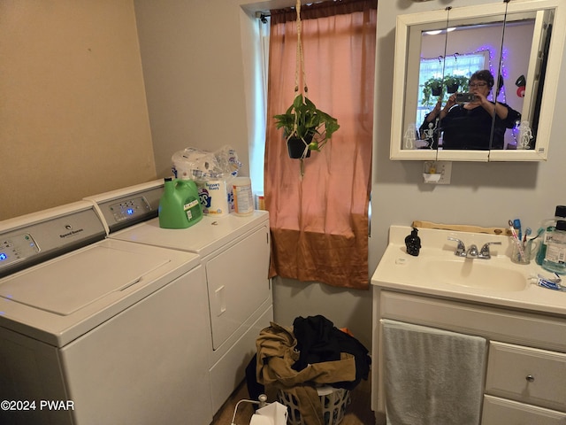 clothes washing area with sink and washing machine and clothes dryer