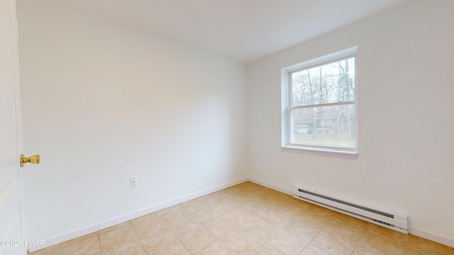 empty room featuring a baseboard heating unit and baseboards
