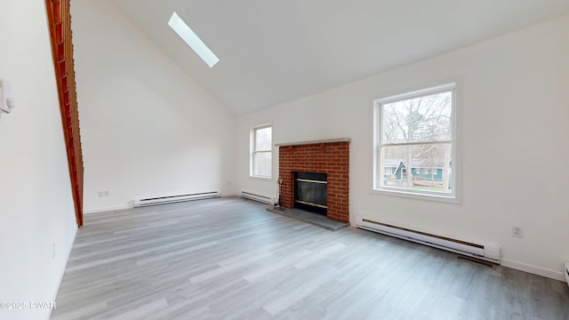 unfurnished living room featuring a baseboard heating unit, wood finished floors, a baseboard radiator, and a skylight