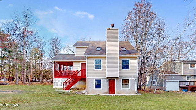rear view of house featuring a chimney, a wooden deck, stairway, and a yard