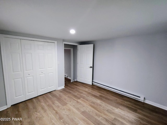 104 Radcliff Rd, Bushkill, PA 18324 - unfurnished bedroom featuring a baseboard heating unit, wood finished floors, a closet, baseboards, and recessed lighting
