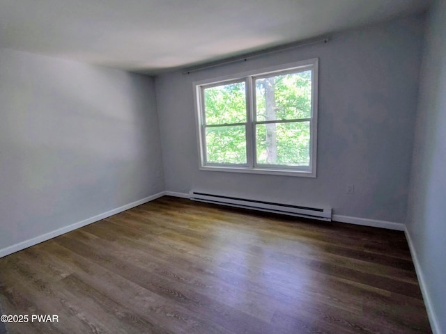 104 Radcliff Rd, Bushkill, PA 18324 - empty room featuring a baseboard radiator, dark wood finished floors, and baseboards