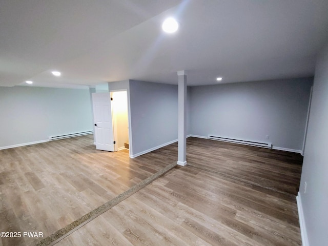 104 Radcliff Rd, Bushkill, PA 18324 - finished below grade area with a baseboard radiator, wood finished floors, recessed lighting, and baseboards