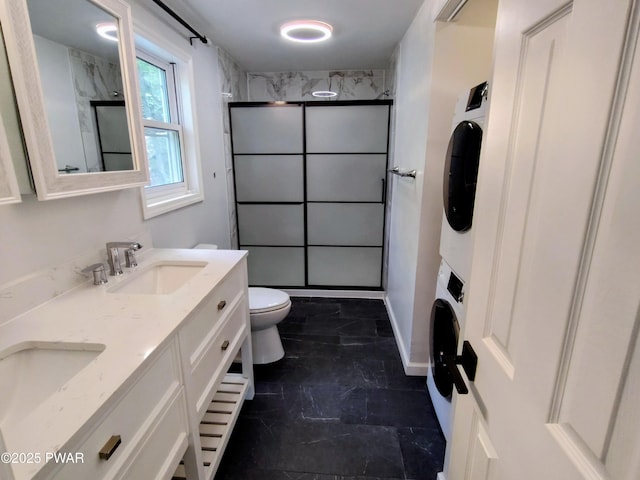 104 Radcliff Rd, Bushkill, PA 18324 - full bathroom with stacked washer / dryer, a shower stall, double vanity, and toilet