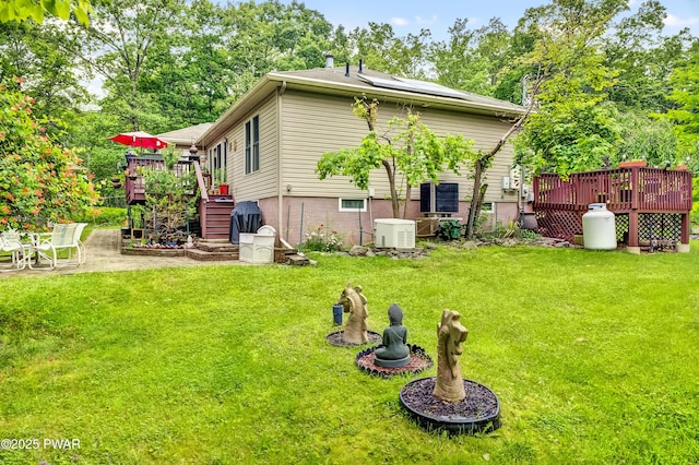 1419 Bear Dr, Bushkill, PA 18324 - back of house featuring a wooden deck, a patio area, and a lawn