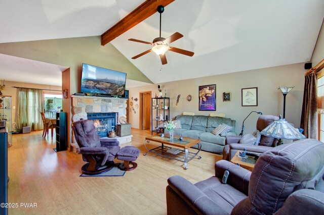 1419 Bear Dr, Bushkill, PA 18324 - living room featuring ceiling fan, a stone fireplace, and light wood finished floors