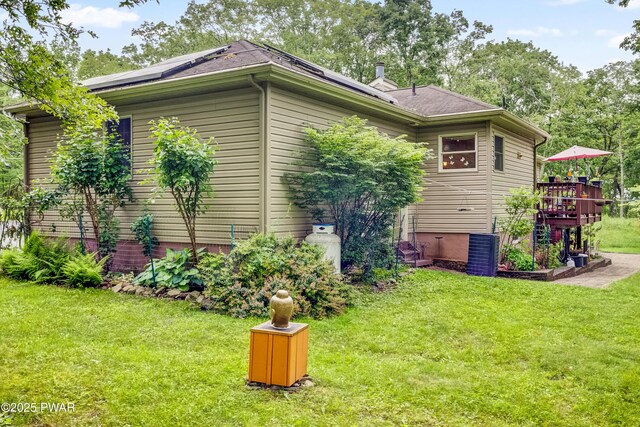 1419 Bear Dr, Bushkill, PA 18324 - view of side of home featuring a yard, solar panels, and a wooden deck
