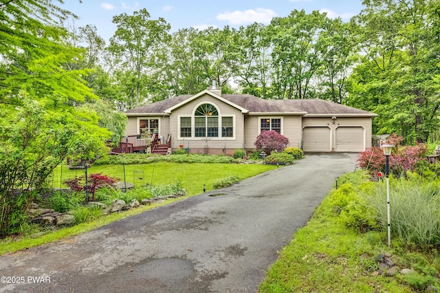 1419 Bear Dr, Bushkill, PA 18324 - single story home with an attached garage, asphalt driveway, a front lawn, a chimney, and a wooden deck
