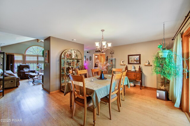 1419 Bear Dr, Bushkill, PA 18324 - dining area with light wood-type flooring, a chandelier, and plenty of natural light