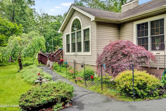 1419 Bear Dr, Bushkill, PA 18324 - view of property exterior featuring a chimney and a lawn