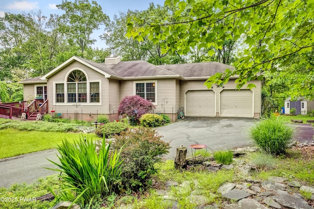1419 Bear Dr, Bushkill, PA 18324 - single story home featuring a garage, asphalt driveway, a chimney, and a front lawn