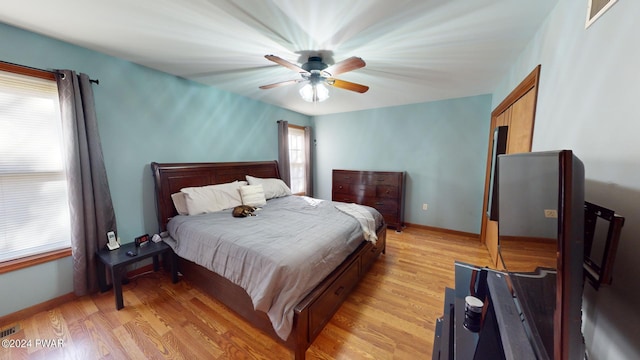 bedroom with light wood-type flooring and ceiling fan