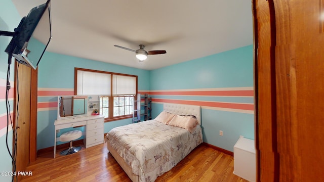 bedroom with ceiling fan and light hardwood / wood-style floors