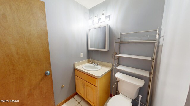 bathroom with tile patterned floors, vanity, and toilet