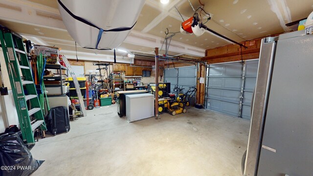 garage with a garage door opener and fridge