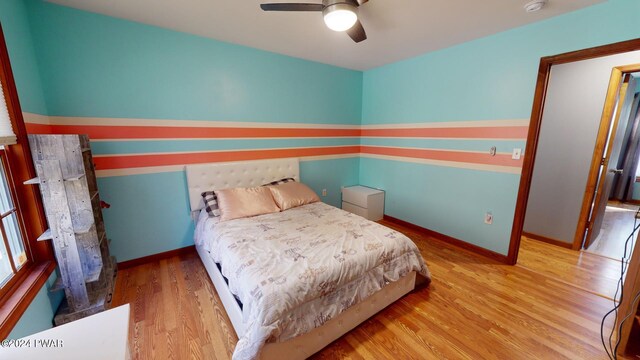 bedroom with ceiling fan and light wood-type flooring