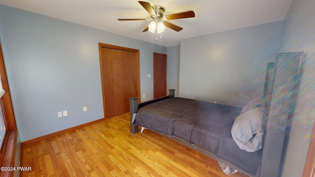 bedroom featuring light wood-type flooring, a closet, and ceiling fan