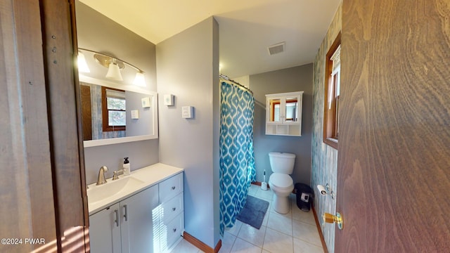 bathroom with tile patterned floors, vanity, and toilet