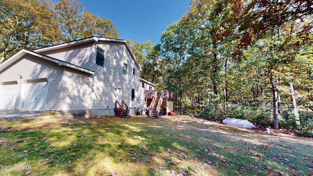 view of side of home featuring a yard and a deck