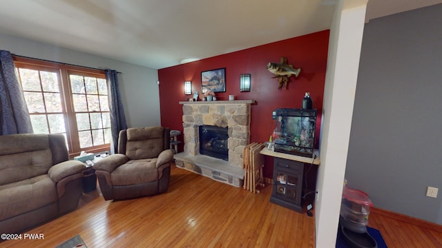 living room with a fireplace and hardwood / wood-style flooring