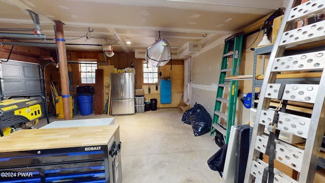 garage with stainless steel refrigerator