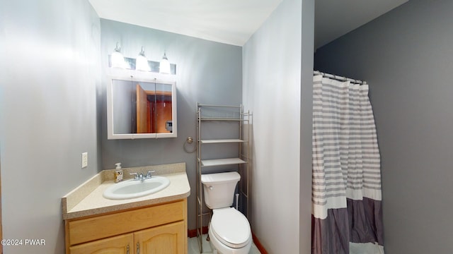 bathroom featuring curtained shower, vanity, and toilet