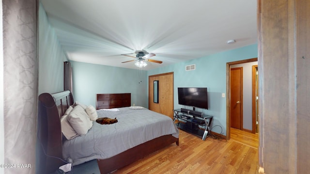 bedroom with ceiling fan and light wood-type flooring