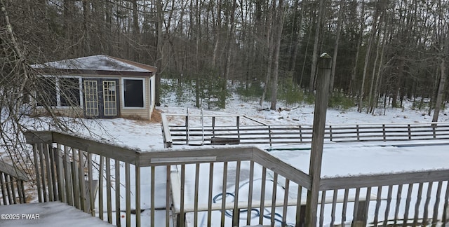 snow covered deck with an outdoor structure