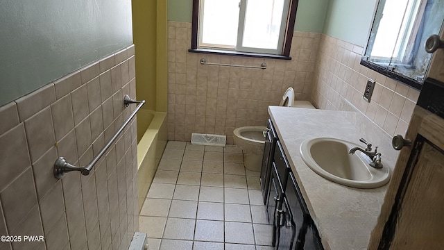 bathroom featuring visible vents, tile patterned flooring, vanity, and tile walls