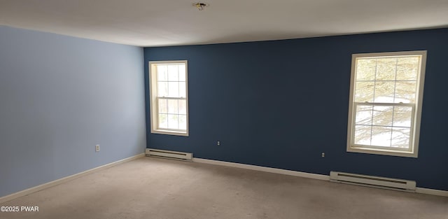 unfurnished room with carpet, baseboards, and a baseboard heating unit